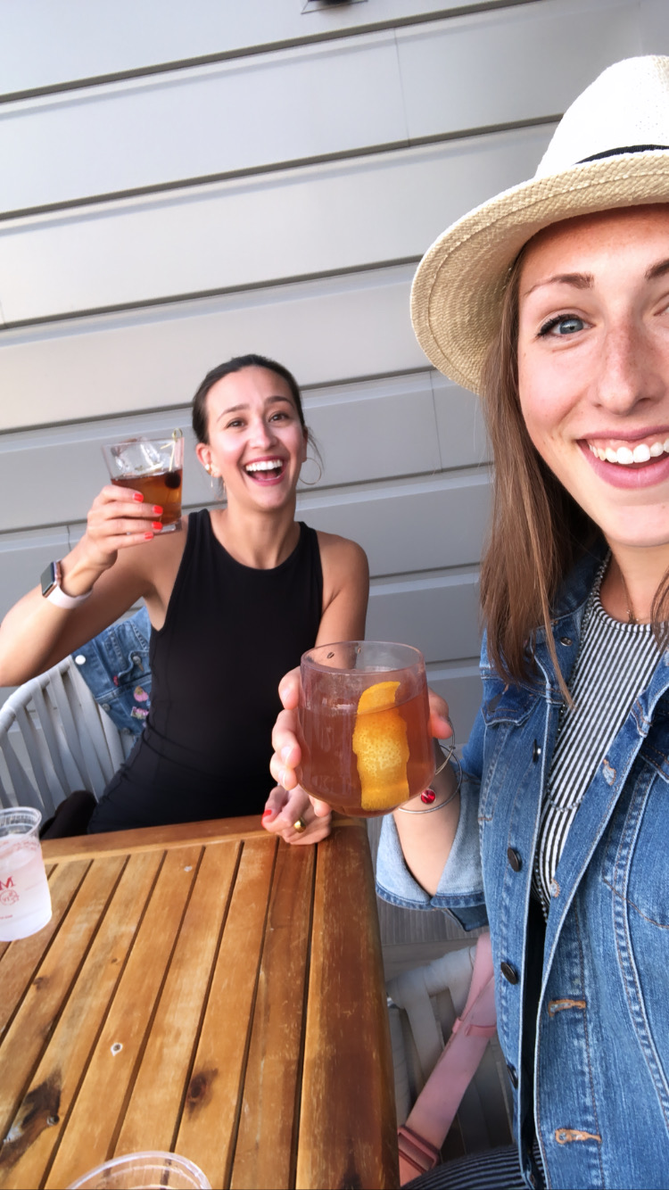 Haley and her friend holding drinks to cheers