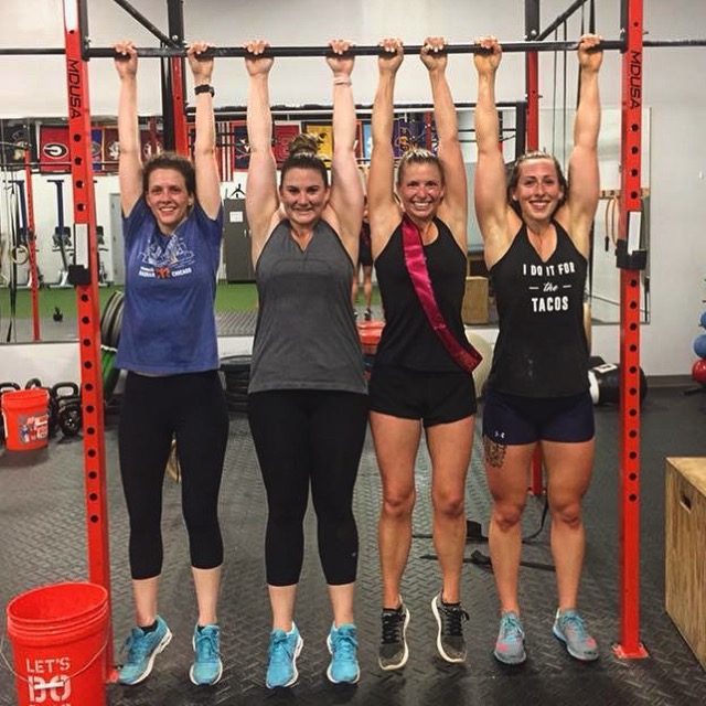 Haley and her friends hang from a bar